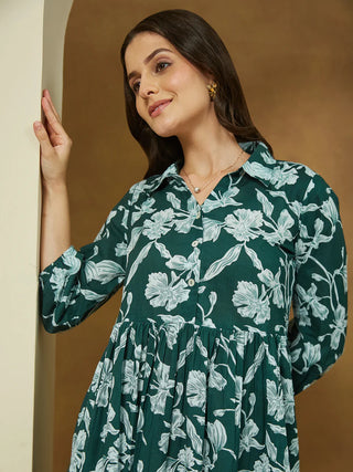 This dark green cotton dress features a flattering gathered waist and feminine 3/4 puffed sleeves. Its floral print and shirt collar add charm, while the breathable fabric and side pocket ensure comfort all day. Ideal for brunch, casual days, or relaxed office wear, it’s a fresh addition to your wardrobe.